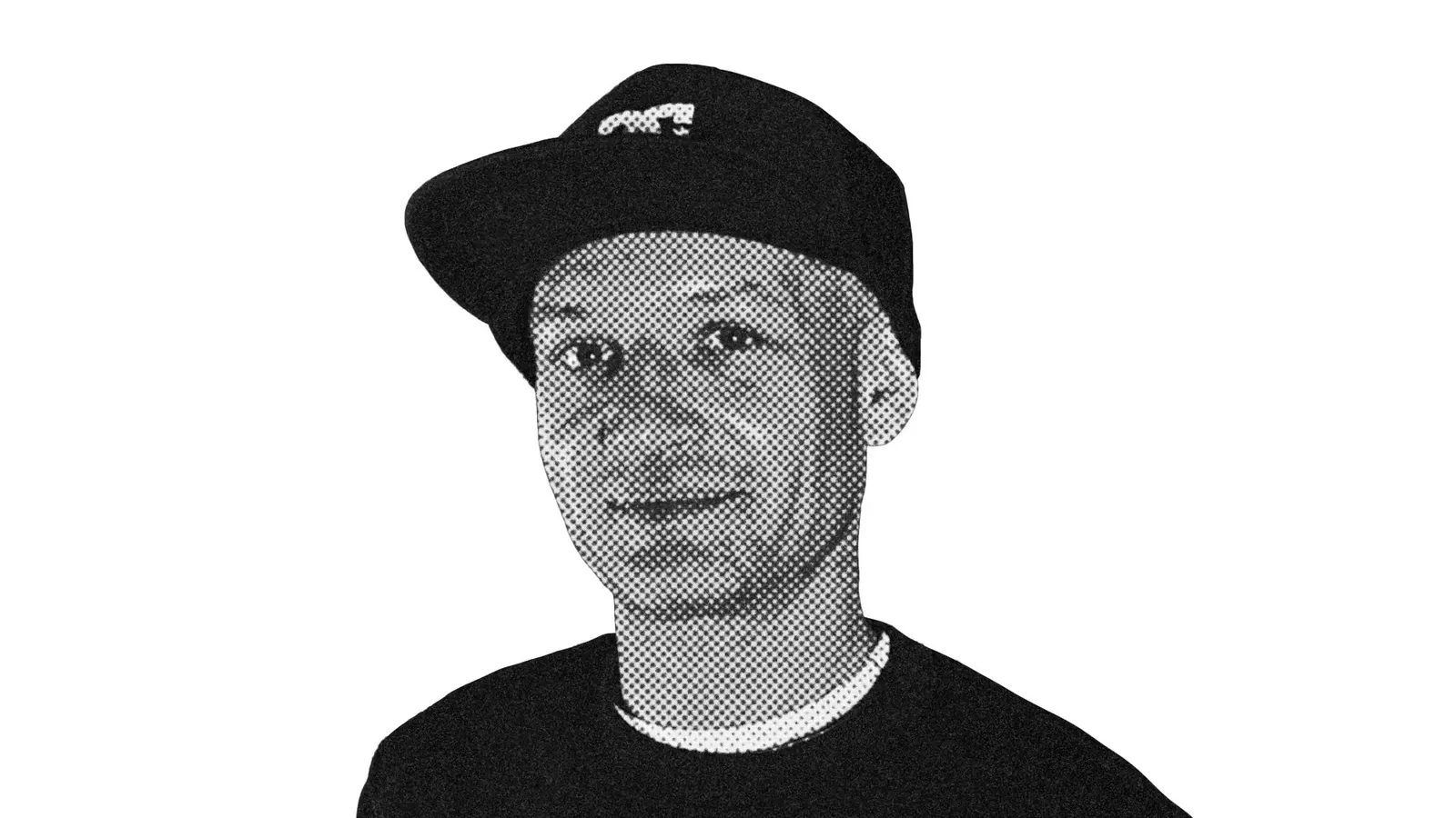 A black and white photo of a man wearing a hat.